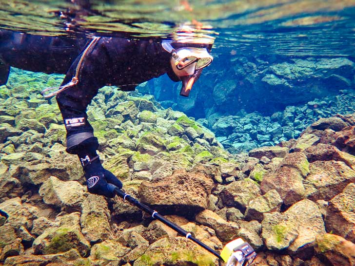 Snorkeling Silfra Fissure Þingvellir National Park Iceland - Snorkel between the continental plates of Eurasia and North America. The underwater visibility is over 100 m and the water is pristine and drinkable during your dive or snorkel // localadventurer.com