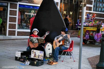 Listening to buskers at Pack Square, Downtown Asheville NC - You can find all genres of musicians congregating on street corners and in front of shops giving the public a show // localadventurer.com