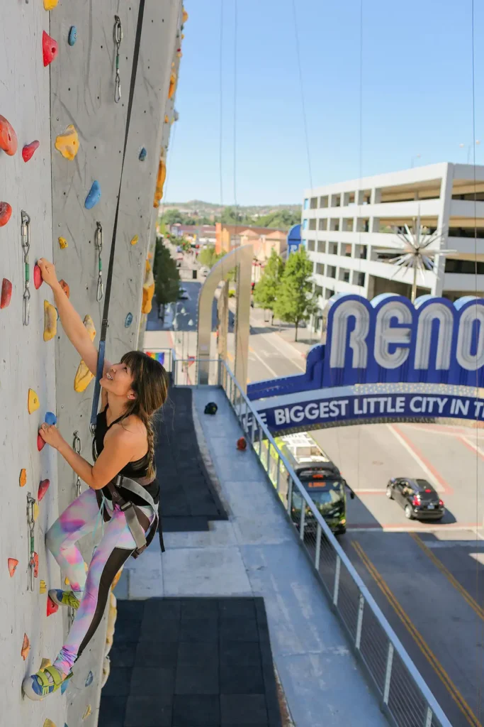 Asian woman climbing the worlds tallest climbing wall at Basecamp Climbing Reno Nevada.
